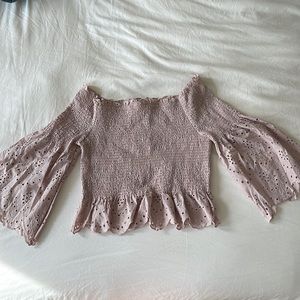 Light pink smocked off the shoulder crop top with bell sleeves.